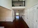 Two-story foyer with hardwood floors and a view of the living room at 1529 Evergreen Hollow Ln, Conyers, GA 30012