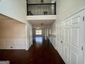 Two-story foyer with hardwood floors and a view of the living room at 1529 Evergreen Hollow Ln, Conyers, GA 30012