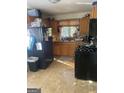 Kitchen with wood cabinets and gas stove at 8965 Campbellton St, Douglasville, GA 30134