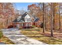 Brick home with a curved driveway and wooded setting at 340 Antebellum Way, Fayetteville, GA 30215