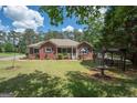 Brick ranch home with screened porch and landscaped yard at 611 Bernhard Rd, Fayetteville, GA 30215