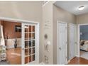 Bright entryway with French doors, coat closet, and view into the living room at 2169 Parador Bnd, Mcdonough, GA 30253