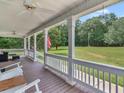 Spacious front porch with wooden floors and white columns at 2110 Mcgarity Rd, Mcdonough, GA 30252