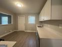 Modern kitchen with white cabinets, quartz countertops, and stainless steel appliances at 2658 Rollingwood Se Ln, Atlanta, GA 30316