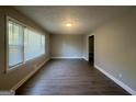 Spacious living room featuring hardwood floors and large windows at 2658 Rollingwood Se Ln, Atlanta, GA 30316