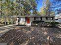 Brick ranch home with a red front door and carport at 4906 Springbrook Dr, Douglasville, GA 30135