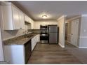 Galley style kitchen with granite counters and stainless appliances at 4906 Springbrook Dr, Douglasville, GA 30135