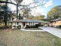 Charming ranch home featuring a carport and spacious front yard at 1737 Mckenzie Dr, Decatur, GA 30032