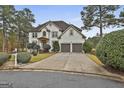 Two-story house with white exterior, landscaping, and a two-car garage at 12021 Scottish Ct, Fayetteville, GA 30215