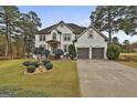 Two-story house with white exterior, landscaping, and a two-car garage at 12021 Scottish Ct, Fayetteville, GA 30215