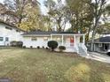 Charming brick ranch home with a red front door and well-manicured lawn at 2228 Sw Springdale Cir, Atlanta, GA 30315