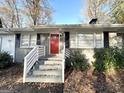 House exterior featuring a red front door and white railings at 8406 Norris Lake Rd, Snellville, GA 30039