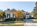 Stunning curb appeal! This home features a classic design and mature trees at 9602 Coastal Pointe Dr, Villa Rica, GA 30180