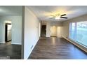 Open living area with wood-look floors, large windows, and views to kitchen and entryway at 2910 Jerome Rd, Atlanta, GA 30349