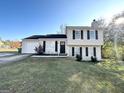 Tan two-story house featuring a garage and well-maintained lawn at 4982 Millstone Walk, Stone Mountain, GA 30088