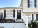 Inviting front entrance with a black door and white railings at 4982 Millstone Walk, Stone Mountain, GA 30088