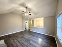 Living room with hardwood floors, open concept floorplan and view into kitchen at 55 Stone Creek Dr, Covington, GA 30016