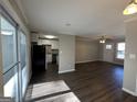 Open concept living area with dark hardwood floors and a view of the kitchen at 2057 Sombrero Se Way, Atlanta, GA 30316