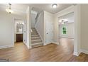 Bright landing with staircase, half bathroom, and view into living room at 2275 Lovejoy Rd # 72, Hampton, GA 30228