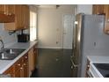 Galley kitchen with stainless steel appliances and tile floor at 637 Fieldcrest Dr, Mcdonough, GA 30253