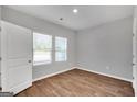 Simple bedroom with wood-look floors and white door at 5374 Tolar Rd # 79, South Fulton, GA 30213