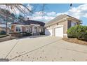 Brick home with a three-car garage and circular driveway at 6061 Golf View Xing, Locust Grove, GA 30248