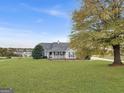 Ranch style home with large yard and mature trees in front at 231 Ferguson Ave, Locust Grove, GA 30248