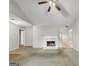 Living room featuring a fireplace and vaulted ceiling at 231 Ferguson Ave, Locust Grove, GA 30248