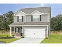 Two-story house with gray siding, white garage door, and landscaping at 133 Avondale Blvd, Conyers, GA 30013