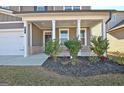 Covered front porch with gray siding and brick accents at 371 Caledonia Ct N, Peachtree City, GA 30269