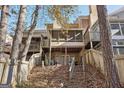 Multi-level wooden decks, and screened-in porch offer outdoor space in a verdant backyard at 3863 Meeting St, Duluth, GA 30096