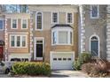 Charming townhome featuring classic architectural details and a well-maintained front yard with a one-car garage at 3863 Meeting St, Duluth, GA 30096