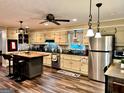 Updated kitchen with island, stainless steel appliances, and hardwood floors at 787 Pine Needle Rd, Hampton, GA 30228