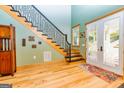 Elegant entry with hardwood floors and staircase at 242 Kirkley Rd, Tyrone, GA 30290