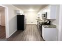 Modern kitchen with white cabinets, granite counters, and stainless steel appliances at 3568 Glenview Cir, Atlanta, GA 30331