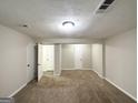 Spacious basement bedroom with carpeted floor and multiple closets at 2852 Port Royal Ln, Decatur, GA 30034
