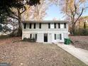 Two-story house with gray siding, landscaping, and a paved driveway at 2852 Port Royal Ln, Decatur, GA 30034