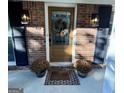 Inviting front door with wreath, flanked by lanterns at 1667 Fernleaf Nw Cir, Atlanta, GA 30318