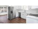 Modern kitchen with white cabinets, stainless steel appliances, and marble countertops at 6864 Fielder Rd, Rex, GA 30273