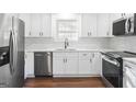 Updated kitchen with white cabinets, stainless steel appliances, and marble countertops at 6864 Fielder Rd, Rex, GA 30273
