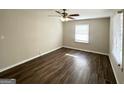 Bright bedroom with dark laminate wood flooring and ceiling fan at 3800 Clovis Nw Ct, Atlanta, GA 30331