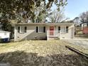 Newly renovated ranch home with red door and landscaping at 3800 Clovis Nw Ct, Atlanta, GA 30331