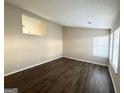 Bright living room with dark laminate floors and neutral walls at 2312 Leslie Brook Dr, Decatur, GA 30035
