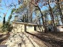 Ranch home nestled among mature trees, featuring a long driveway at 4448 Malibu Dr, Decatur, GA 30035