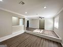 Spacious living area with hardwood floors and built-in shelving at 4448 Malibu Dr, Decatur, GA 30035