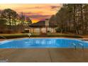 Inviting backyard pool with a pergola and patio at 409 Bellway Ct, Tyrone, GA 30290