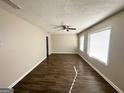 Spacious living room with hardwood floors and ceiling fan at 3438 Maryvale Dr, Decatur, GA 30032