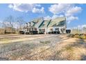 Two-story house with green roof, white siding, and large front porch at 2800 S Highway 16, Carrollton, GA 30116