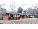 Newly renovated brick ranch house with a large front yard and mature trees at 2193 Hiram Douglasville Hwy, Hiram, GA 30141