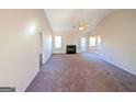 Spacious living room with vaulted ceiling, fireplace, and access to other rooms at 6195 Winston Trce, Mcdonough, GA 30252
